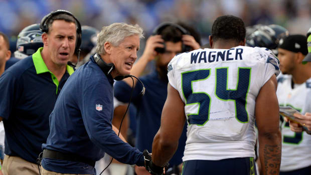 Seattle Seahawks head coach Pete Carroll talks to middle linebacker Bobby Wagner (54) after they stopped Baltimore Ravens on fourth down during the second half at M&T Bank Stadium. Seattle Seahawks defeated Baltimore Ravens 35-6.
